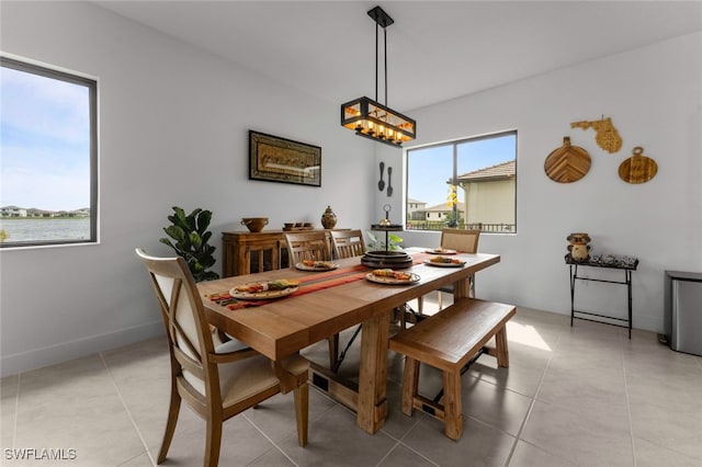 dining area featuring baseboards and light tile patterned floors