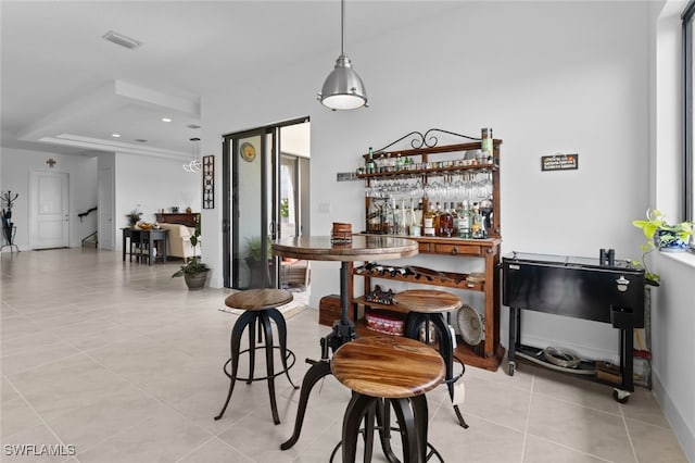 bar featuring a bar, light tile patterned floors, visible vents, and recessed lighting