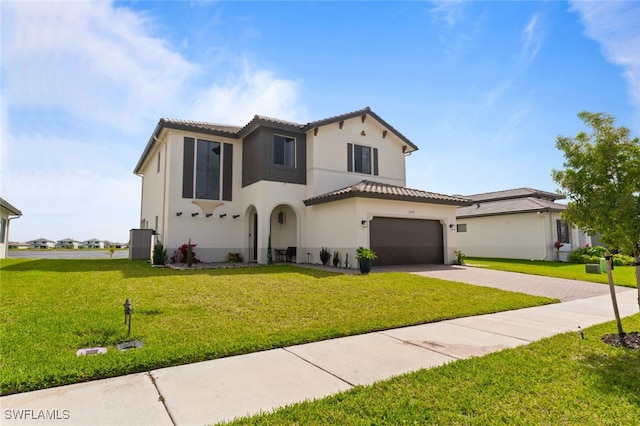 mediterranean / spanish-style home with driveway, a tiled roof, a front lawn, central AC, and stucco siding