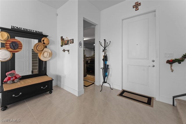 mudroom featuring baseboards and light tile patterned floors