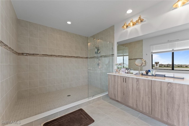 full bathroom featuring recessed lighting, tile patterned flooring, a walk in shower, and vanity