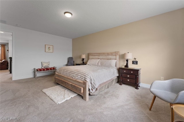 bedroom with carpet, visible vents, and baseboards