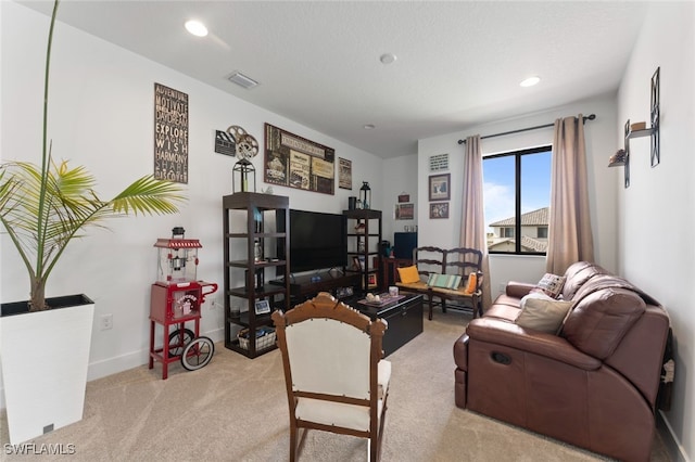 living area with visible vents, baseboards, carpet, a textured ceiling, and recessed lighting