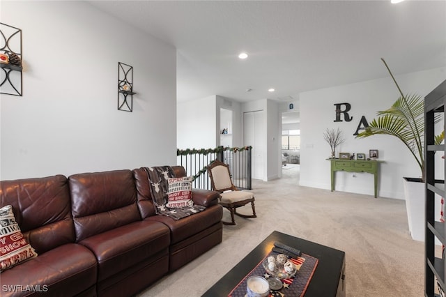 living area with recessed lighting, baseboards, and light colored carpet