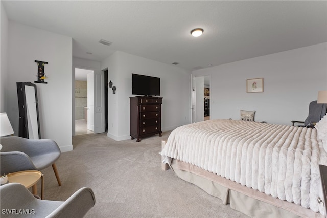 bedroom featuring baseboards, visible vents, and light colored carpet