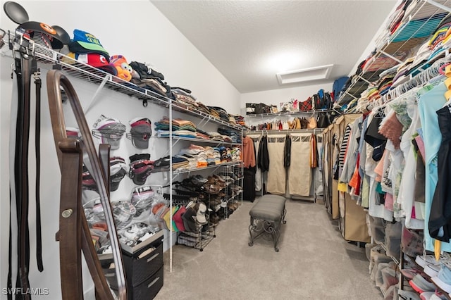 spacious closet with carpet flooring and attic access