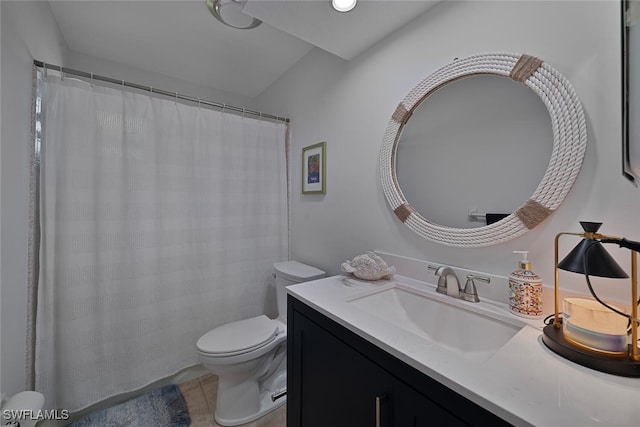 bathroom with tile patterned flooring, vanity, and toilet