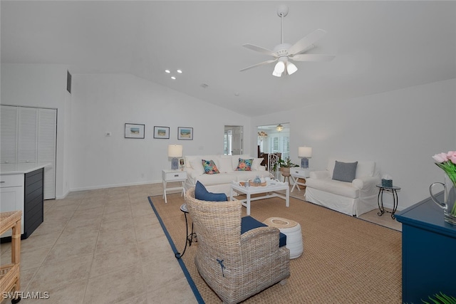 living room featuring vaulted ceiling, light tile patterned floors, a ceiling fan, and baseboards