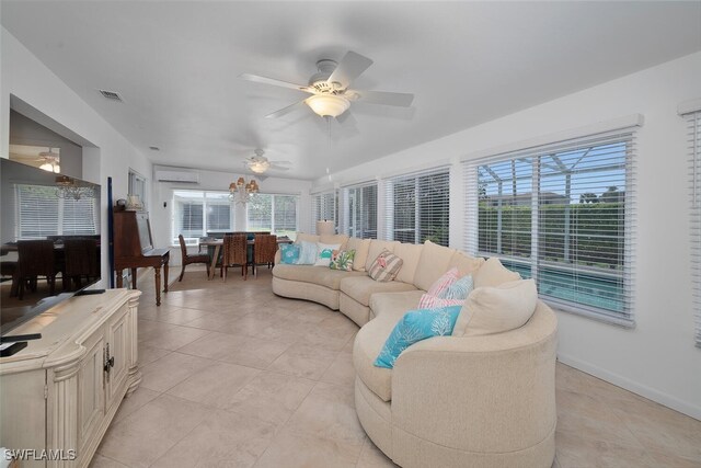 sunroom featuring visible vents, ceiling fan, and a wall mounted AC