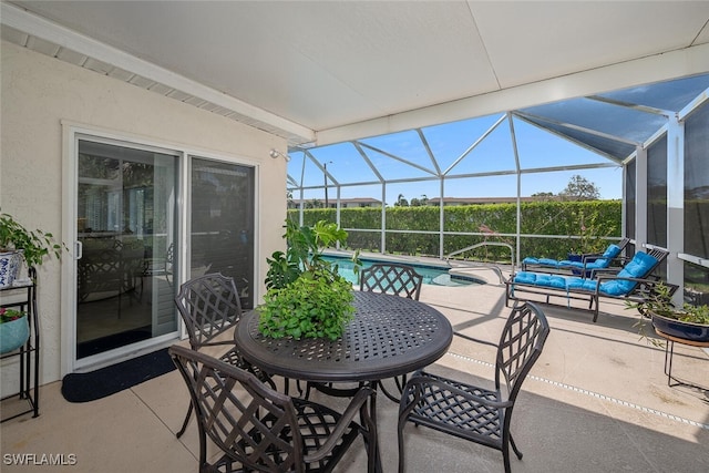 view of patio featuring glass enclosure and an outdoor pool