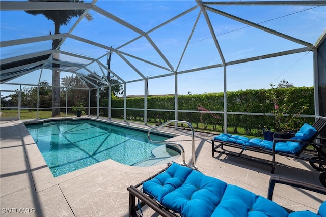 pool with a lanai, outdoor lounge area, and a patio