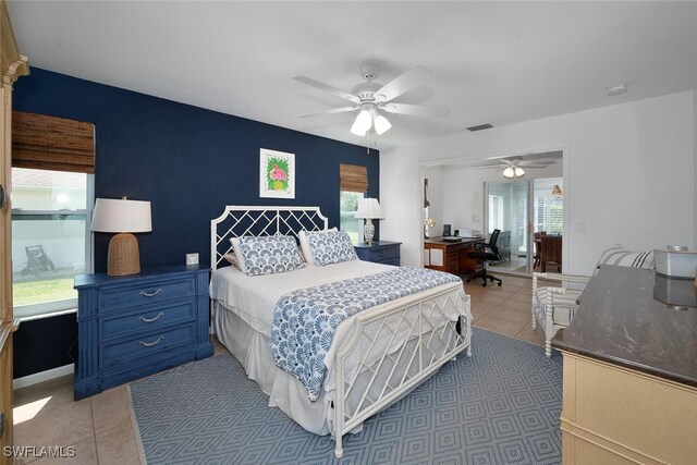 bedroom with light tile patterned floors, ceiling fan, and visible vents