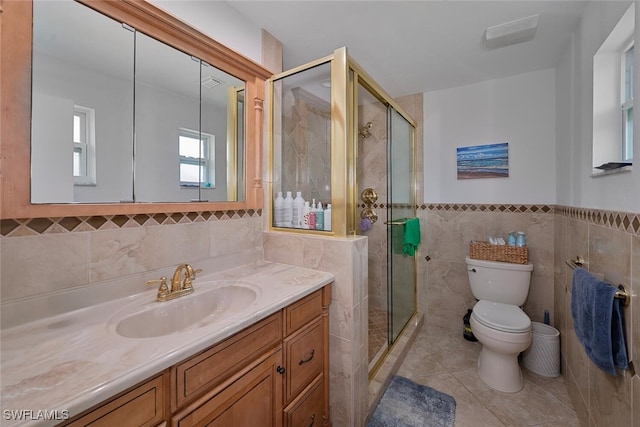 full bath featuring tile walls, toilet, a shower stall, vanity, and tile patterned flooring