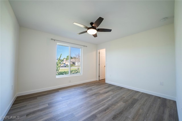 empty room with wood finished floors, baseboards, and ceiling fan