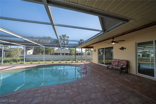 view of swimming pool featuring a fenced in pool, fence, a lanai, a patio, and a ceiling fan