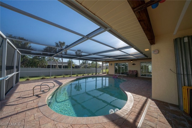 view of pool featuring a patio area, fence, a fenced in pool, and a lanai