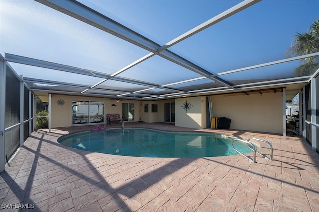 outdoor pool featuring a lanai and a patio area