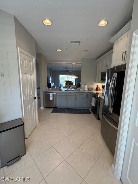 kitchen featuring light tile patterned floors, visible vents, appliances with stainless steel finishes, and a sink