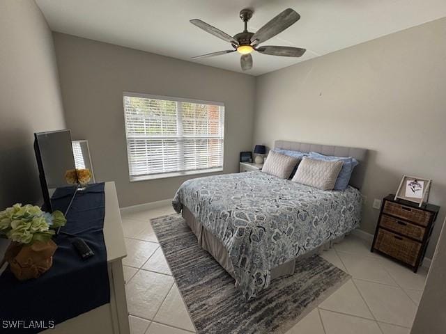 bedroom featuring light tile patterned floors, ceiling fan, and baseboards