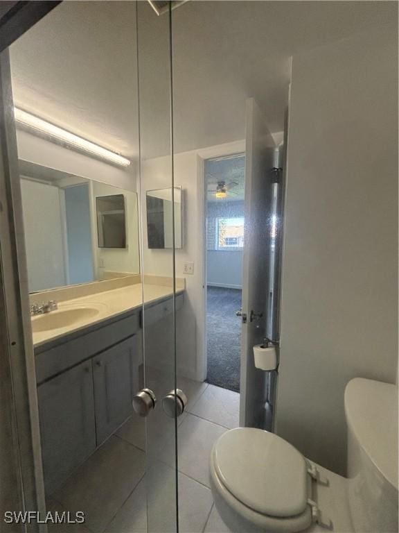 bathroom with tile patterned flooring, vanity, and toilet