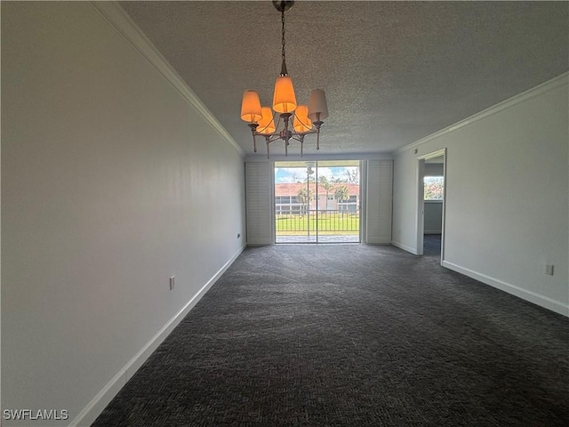 empty room with dark carpet, ornamental molding, a textured ceiling, a chandelier, and baseboards