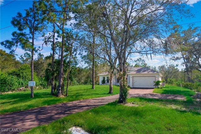 ranch-style home featuring driveway, a front lawn, and an attached garage