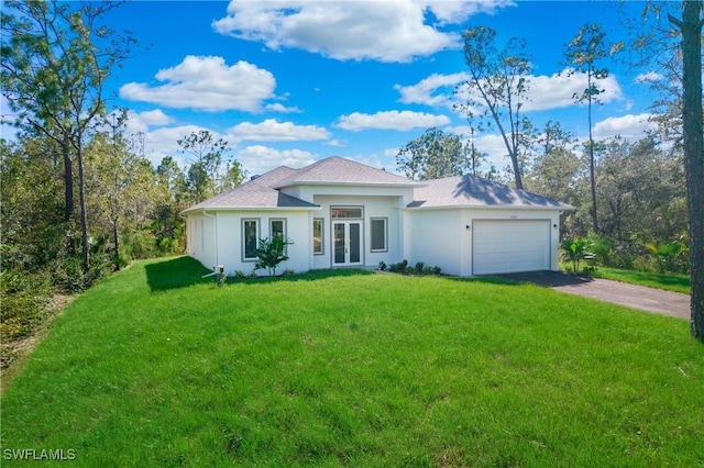 view of front of property featuring a garage, a front lawn, and aphalt driveway