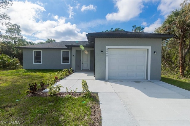 single story home with a garage, a front lawn, concrete driveway, and stucco siding