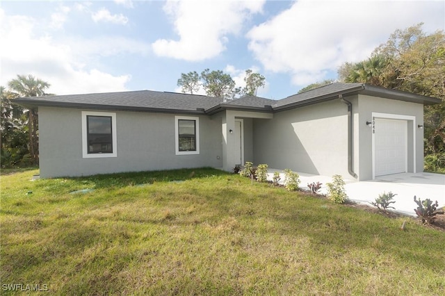 view of front facade with a garage, a front lawn, concrete driveway, and stucco siding