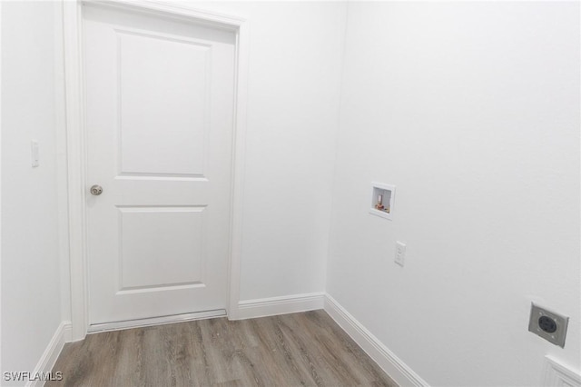 laundry area with laundry area, baseboards, wood finished floors, washer hookup, and electric dryer hookup