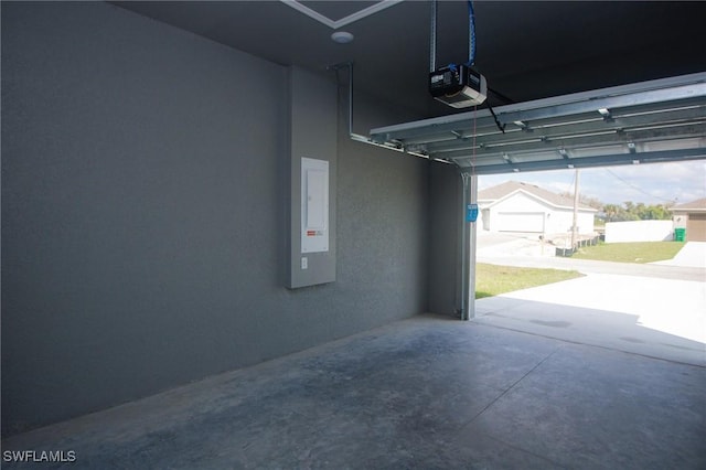 garage featuring electric panel and a garage door opener