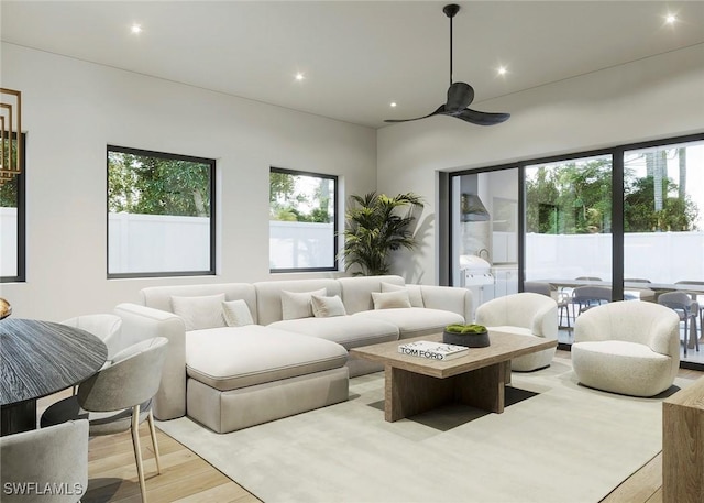 living area with light wood-type flooring and recessed lighting