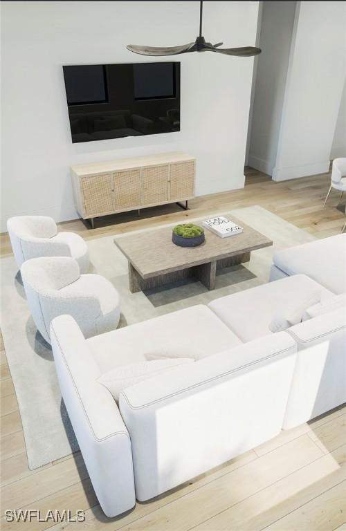 living area with light wood-style flooring and ceiling fan