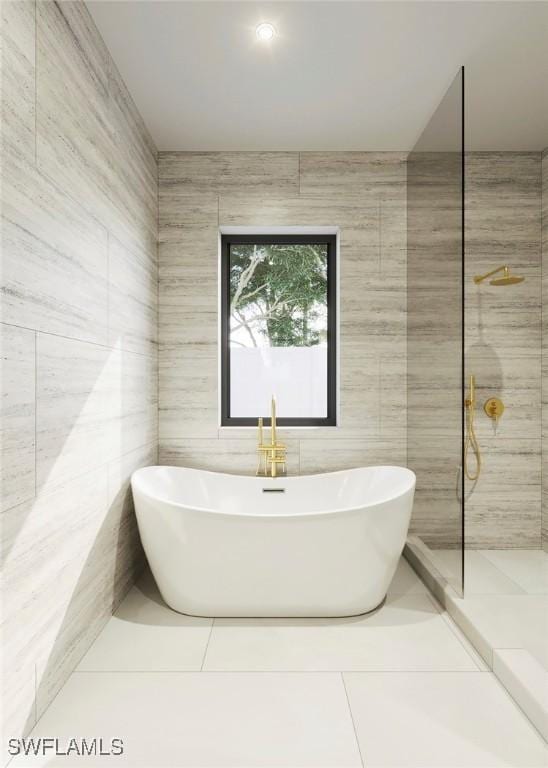 full bathroom featuring tile patterned flooring, tile walls, a walk in shower, and a freestanding bath