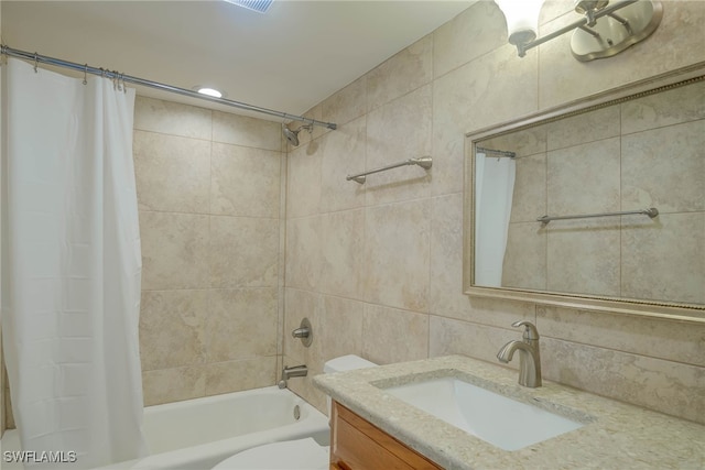 full bathroom featuring shower / tub combo, tile walls, toilet, vanity, and backsplash