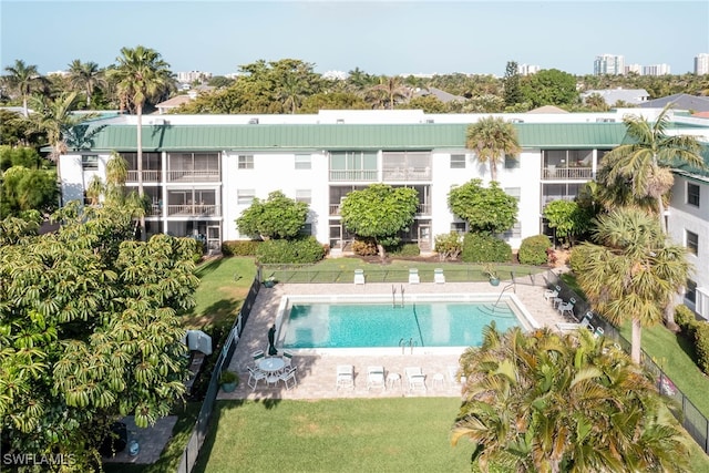 community pool featuring a yard and a patio