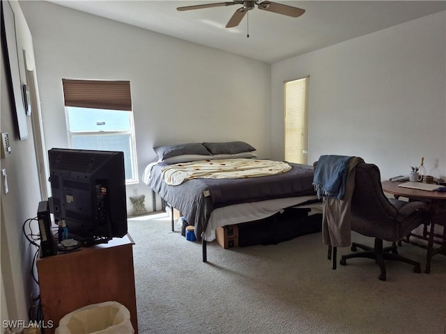 carpeted bedroom featuring a ceiling fan and vaulted ceiling