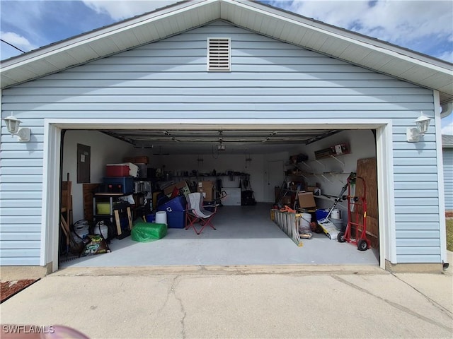 garage featuring driveway and electric panel