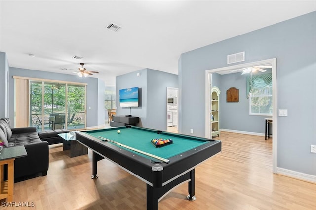 rec room with a wealth of natural light, visible vents, and light wood-type flooring