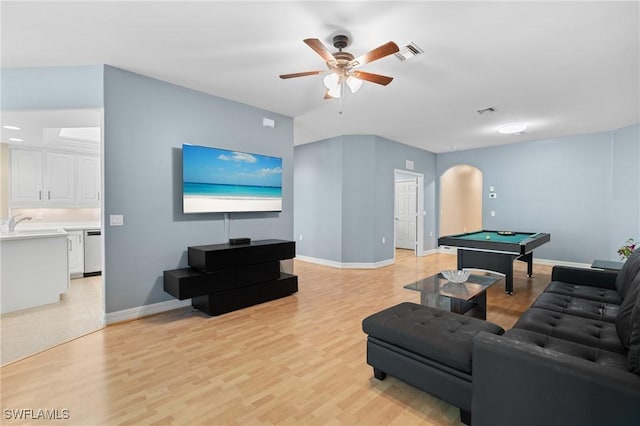 living room featuring billiards, visible vents, arched walkways, ceiling fan, and light wood-type flooring