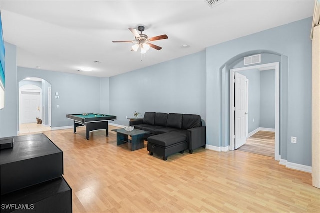 living area featuring visible vents, light wood-style flooring, arched walkways, ceiling fan, and pool table