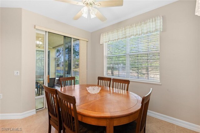 dining room with light tile patterned floors, ceiling fan, and baseboards