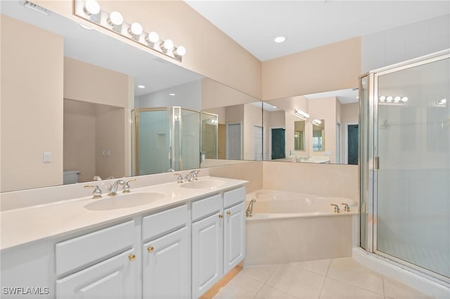 bathroom with a sink, a garden tub, a stall shower, and tile patterned floors