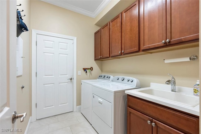 clothes washing area featuring ornamental molding, washer and clothes dryer, a sink, cabinet space, and light tile patterned flooring
