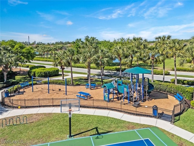 view of home's community featuring fence, playground community, and a lawn