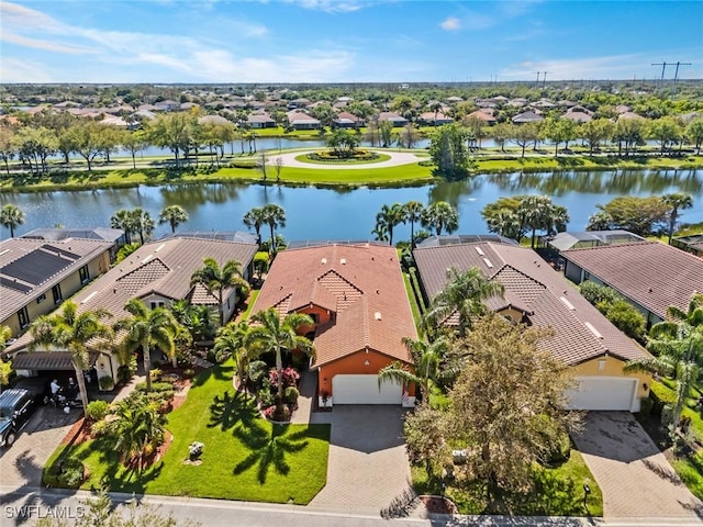 drone / aerial view featuring a residential view and a water view