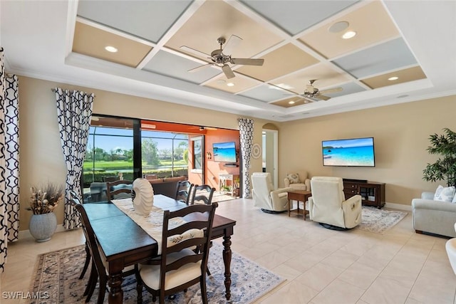 dining room featuring ornamental molding, a ceiling fan, coffered ceiling, arched walkways, and baseboards