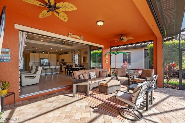 view of patio with an outdoor hangout area, a lanai, and a ceiling fan