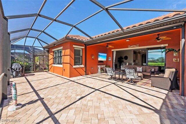 view of patio with an outdoor living space, a lanai, and a ceiling fan
