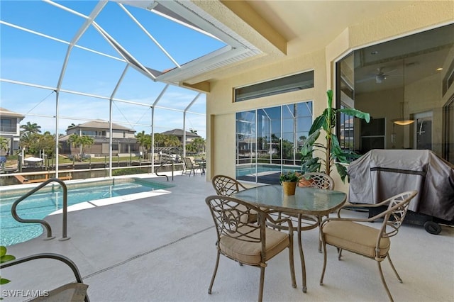 view of patio / terrace with an outdoor pool, glass enclosure, outdoor dining area, and grilling area